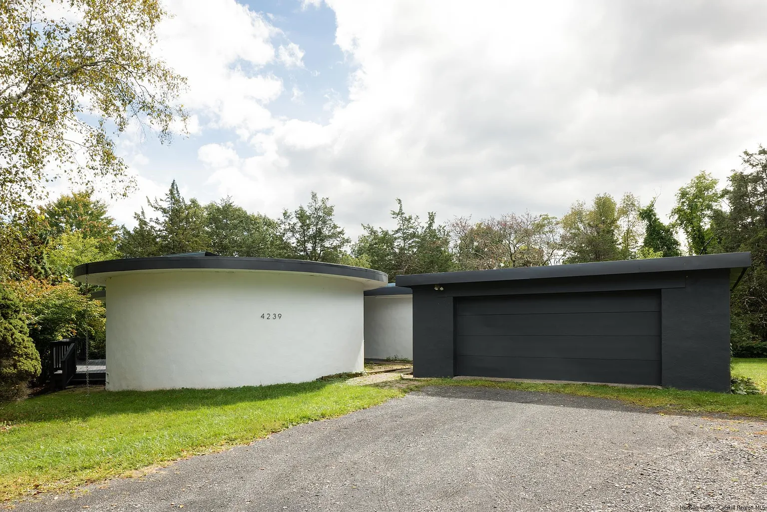 Rotunda House, a distinctive round home surrounded by trees in Stone Ridge, NY